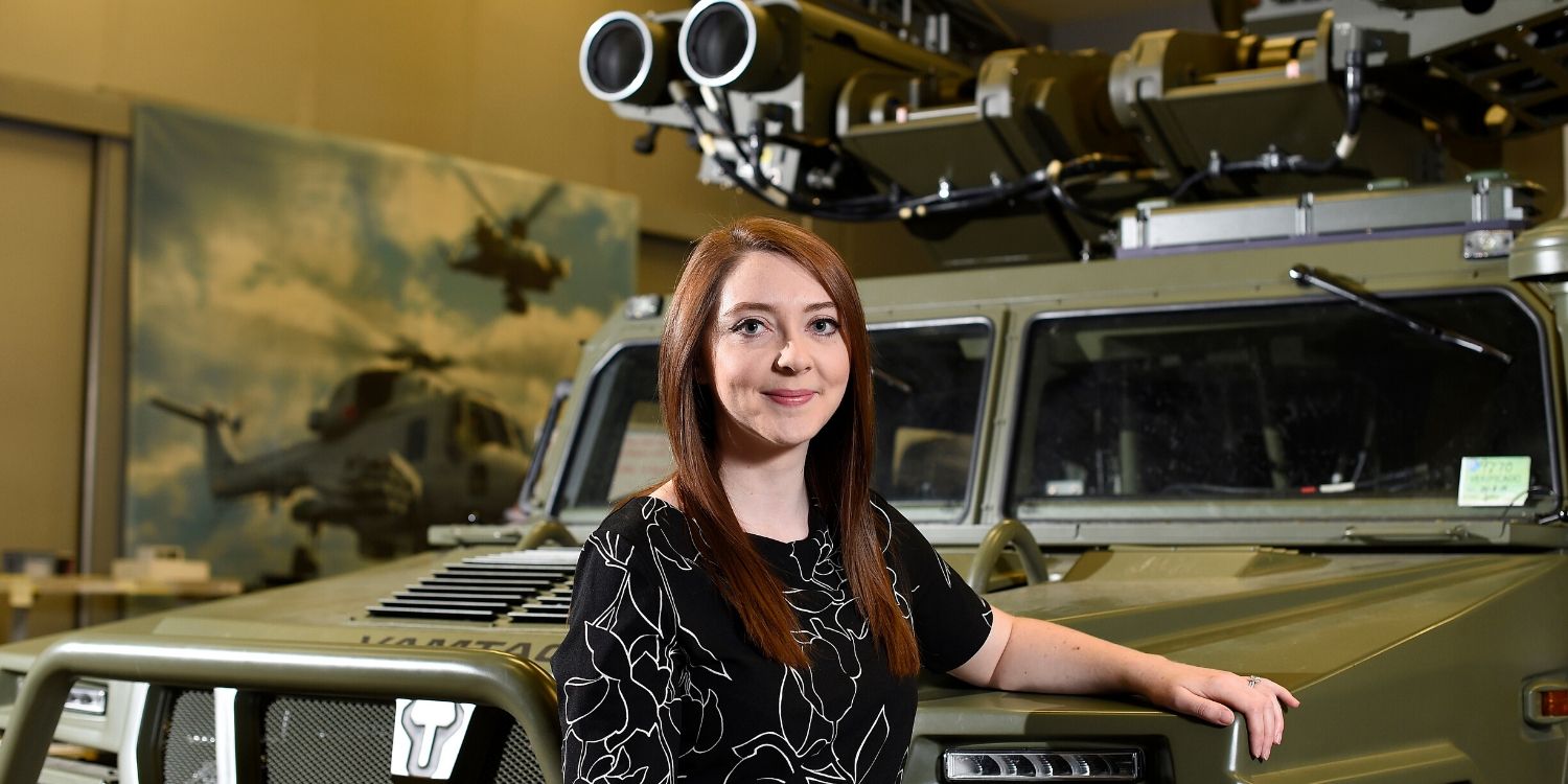 Lesley Torbet standing by a heavily modified vehicle at Thales UK.