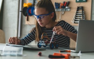 girl using tablet working on engineering / robotics project