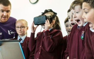 A man demonstrates VR to a group of surprised children